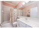 Bathroom with a shower/tub combo, white vanity, and framed mirror at 10523 Old Grove Cir, Bradenton, FL 34212