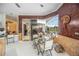 Bright breakfast nook with tile flooring, glass table, and views of outdoor scenery at 10523 Old Grove Cir, Bradenton, FL 34212