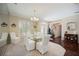 Dining room with a chandelier, shuttered windows, and elegant furnishings at 10523 Old Grove Cir, Bradenton, FL 34212