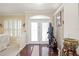 Foyer with hardwood floors, a decorative statue, and a bright, welcoming atmosphere at 10523 Old Grove Cir, Bradenton, FL 34212