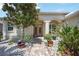 Inviting front entrance with a brick walkway, lush plants, and manicured landscaping at 10523 Old Grove Cir, Bradenton, FL 34212