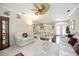Open-concept living room with neutral decor, comfortable seating, and a dining area at 10523 Old Grove Cir, Bradenton, FL 34212