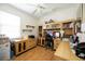 Bright office space with custom wooden built-ins, desk, and multiple computer setups at 10523 Old Grove Cir, Bradenton, FL 34212