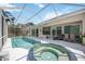 Screened pool and spa with outdoor seating, great for relaxing and entertaining at 10523 Old Grove Cir, Bradenton, FL 34212