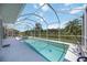 Screened pool and spa overlooking a lake view with tropical foliage at 10523 Old Grove Cir, Bradenton, FL 34212