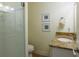 Bathroom featuring tiled shower, vanity, and framed artwork at 112 Palm Ave, Anna Maria, FL 34216
