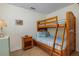 Cozy bedroom featuring bunk beds, a nightstand, and nautical decor at 112 Palm Ave, Anna Maria, FL 34216