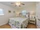 Bright bedroom with a full bed, ceiling fan, and matching bedside tables at 112 Palm Ave, Anna Maria, FL 34216