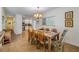 Inviting dining room with a wooden table, six chairs, and natural light from a window at 112 Palm Ave, Anna Maria, FL 34216