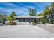 Charming coastal home with a screened porch and lush tropical landscaping at 112 Palm Ave, Anna Maria, FL 34216
