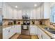 Well-maintained kitchen featuring stainless steel appliances, granite counters, and white cabinets at 112 Palm Ave, Anna Maria, FL 34216