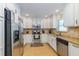 Well-lit kitchen offers stainless steel appliances, granite counters, and tiled backsplash at 112 Palm Ave, Anna Maria, FL 34216
