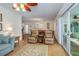 Inviting living room with comfortable recliners and a glimpse of the dining area beyond at 112 Palm Ave, Anna Maria, FL 34216
