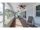 Relaxing screened porch with ceiling fans and comfortable seating area at 112 Palm Ave, Anna Maria, FL 34216