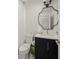 Compact bathroom featuring modern fixtures, a unique mirror, and a clean design for efficient use of space at 120 White Ave, Anna Maria, FL 34216