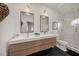 Modern bathroom featuring dual sinks, sleek vanity, and a glass-enclosed shower for a spa-like experience at 120 White Ave, Anna Maria, FL 34216