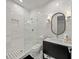 Stylish bathroom with white marble tiling, a glass-enclosed shower, and a modern vanity for a clean look at 120 White Ave, Anna Maria, FL 34216