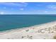 Scenic beach with turquoise water, white sand, and beachgoers enjoying the sunshine on a clear day at 120 White Ave, Anna Maria, FL 34216
