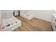 Inviting bedroom showcasing two single beds, wood floors and soft, natural light at 120 White Ave, Anna Maria, FL 34216