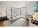 Bright bedroom with hardwood floors and access to balcony creating a relaxing retreat at 120 White Ave, Anna Maria, FL 34216