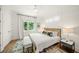 Comfortable bedroom featuring a large window, neutral decor, and ample natural light, creating a serene atmosphere at 120 White Ave, Anna Maria, FL 34216