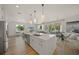 Open concept living and kitchen area with an island, pendant lighting, stainless steel appliances, and dining area at 120 White Ave, Anna Maria, FL 34216