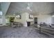 Spacious outdoor living area with a dining area, multiple TVs, and ample seating at 120 White Ave, Anna Maria, FL 34216