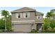 Two-story home featuring a two-car garage, gray paint, shutters, landscaping, and lush palm trees in the front yard at 12027 Lansing Gln, Parrish, FL 34219