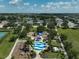 Aerial view of the community playground with splashpad, set amongst lush landscaping near a tranquil lake at 12149 Forest Park Cir, Bradenton, FL 34211