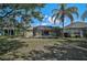 Lovely backyard view featuring a screen enclosed lanai and tropical landscaping at 12149 Forest Park Cir, Bradenton, FL 34211