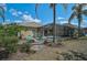 Private backyard oasis with a screened pool, patio area, lush landscaping, and tropical palm trees at 12149 Forest Park Cir, Bradenton, FL 34211