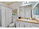 Charming bathroom with fish-themed wallpaper, white vanity, toilet, and shower with curtain rod at 12149 Forest Park Cir, Bradenton, FL 34211