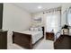 Cozy bedroom features a sleigh bed, decorative pillows, side table with lamp, and bright natural light at 12149 Forest Park Cir, Bradenton, FL 34211