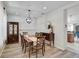 Cozy dining room with stylish chandelier, wood floors, and decorative china cabinet at 12149 Forest Park Cir, Bradenton, FL 34211