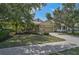 Inviting home exterior with a two-car garage, landscaped yard, and lush trees on a sunny day at 12149 Forest Park Cir, Bradenton, FL 34211