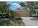 Charming single-Gathering home with a two-car garage, landscaped yard, and a well-maintained lawn on a sunny day at 12149 Forest Park Cir, Bradenton, FL 34211