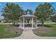 Beautiful community gazebo with a blue roof and white posts surrounded by lush landscaping on a sunny day at 12149 Forest Park Cir, Bradenton, FL 34211