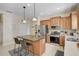 Modern kitchen with an island, stainless steel appliances, wooden cabinets, and sleek countertops at 12149 Forest Park Cir, Bradenton, FL 34211
