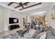 Bright and open living room with modern furnishings, ceiling fan, and seamless flow to the kitchen at 12149 Forest Park Cir, Bradenton, FL 34211