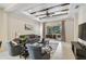 Comfortable living room featuring a decorative tray ceiling, fan, and sliding glass doors to the patio at 12149 Forest Park Cir, Bradenton, FL 34211