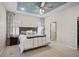 Serene main bedroom with a tray ceiling, plantation shutters, and an en-suite bathroom at 12149 Forest Park Cir, Bradenton, FL 34211