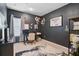 Office featuring a dark wall, computer desk setup, stylish decor, and large patterned rug on light carpet at 12149 Forest Park Cir, Bradenton, FL 34211