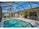 Inviting screened-in pool area with cozy outdoor furniture, perfect for relaxation and entertaining guests at 12149 Forest Park Cir, Bradenton, FL 34211