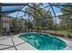 Beautiful screened-in pool with lush landscaping, creating a private and serene outdoor oasis for relaxation at 12149 Forest Park Cir, Bradenton, FL 34211