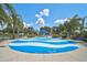 Community splash pad is surrounded by tropical landscaping and benches for lounging at 12149 Forest Park Cir, Bradenton, FL 34211