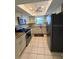 Well-lit kitchen featuring granite counters, white cabinetry, and stainless steel appliances at 1304 56Th W St, Bradenton, FL 34209