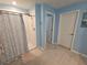 Bright bathroom featuring a shower with white tiled walls and a wood-look tile floor at 13156 Merlot Sunstone Cv, Parrish, FL 34219