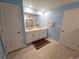 Bright bathroom with dual sink vanity, light blue walls and tile flooring at 13156 Merlot Sunstone Cv, Parrish, FL 34219