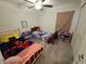 Bedroom with ceiling fan, two twin beds, decorated with colorful comforters and soft lighting at 13156 Merlot Sunstone Cv, Parrish, FL 34219