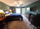 Bedroom featuring a large bed, dark wood furniture, and natural light at 13156 Merlot Sunstone Cv, Parrish, FL 34219